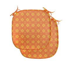 an orange and yellow patterned placemats with ties on each side, set against a white background