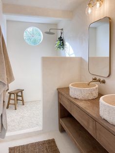 a bathroom with a sink, mirror and stool in it's centerpieces