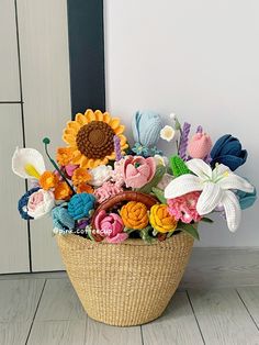 a basket filled with lots of colorful flowers