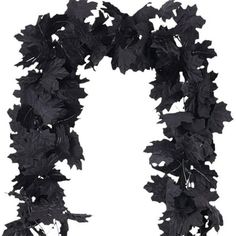 a black wreath with leaves hanging from it's sides, on a white background