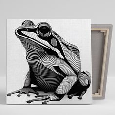 a black and white frog sitting on top of a wooden box