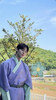 a woman in a purple and green kimono