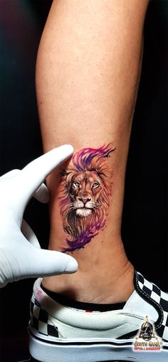 a woman's leg with a lion tattoo on it