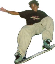 a man in black shirt and white pants doing a trick on a skateboard with one hand