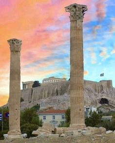 two large stone pillars sitting in front of a building