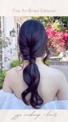 the back of a woman's head with long black hair