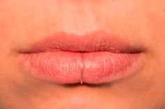 a woman's lips with the tip of her lip sticking out to show redness