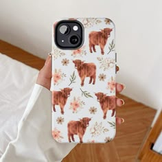 a woman is holding up her phone case with an animal print on the front and back