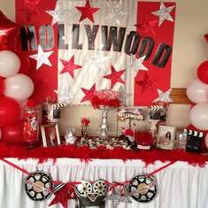 hollywood themed party with red and white balloons, streamers, stars, and decorations