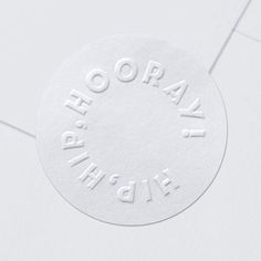 a round white sticker with the words, ohoh okay on it