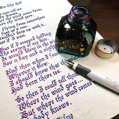 a fountain pen and ink sitting on top of a piece of paper