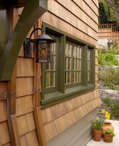 a lamp on the side of a wooden house