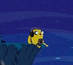 a cartoon character with headphones on holding a cell phone in front of a cliff