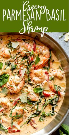 a pan filled with shrimp and spinach on top of a table