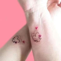 two small tattoos on the arms of someone's hands, one with hearts and stars