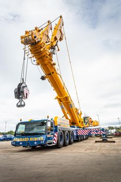 a large crane is being lifted onto a truck bed by a crane operator's lift