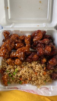 a takeout box filled with rice and chicken