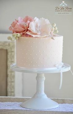 a white cake with pink flowers on top