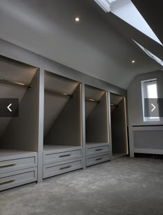 an empty room with some drawers and lights