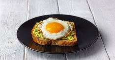 an egg is on top of toast with avocado