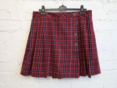 Womens Red Tartan Plaid Mini Skirts Low Waist Pleated Skirts Checkered Skirts Back to School Skirt Wool Blended Scottish Skirt Size L N.B. Color may slightly differ from picture. Label size: 42 Measurements (taken laying flat): Waist: 17.5" / 44.5 cm Hips: 22.5'' / 57 cm  Length: 18.5" / 47 cm Please check measurements to insure a proper fit. Remember to allow yourself some extra room for movement. You can compare these with something from your closet that fits you well. Condition: good Vintage Condition SHIPPING * I ship worldwide via Priority mail. * I ship from Europe, so please allow 2 to 4 weeks for the package to arrive if you live overseas. * Europe 5 - 10 business days. Please also visit my Mother's shops for some more vintage treasurs: https://www.etsy.com/shop/VintageOffer?ref=se Retro Red Bottoms For School, Retro Red School Bottoms, Red Mini Skirt For School In Winter, Preppy Red Skort For School, Red Mini Tennis Skirt For School, Red Lined Skirt For School, Red Pleated Preppy Mini Skirt, Red Pleated Mini Skirt In Preppy Style, Preppy Red Fitted Skort