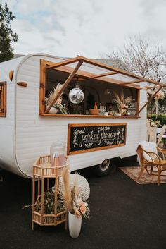 an old camper converted into a mobile home with plants growing out of the windows