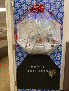 an open door decorated with snow globes and christmas decorations, which reads happy holidays