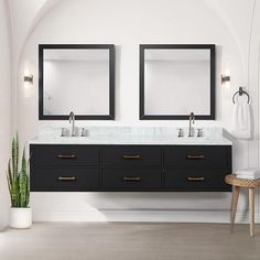 two mirrors are above the double sinks in this white bathroom with black cabinets and drawers