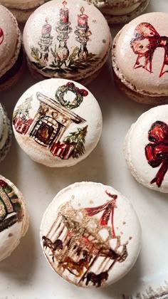 there are many decorated macaroons on the table together, including one with an image