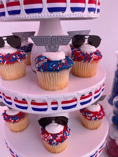 cupcakes are decorated with shades and red, white, and blue frosting