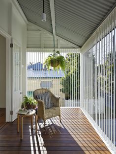 a chair and table sitting on a porch