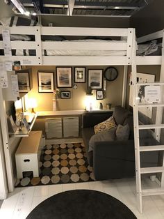 a loft bed with a desk and chair in the corner, next to a couch