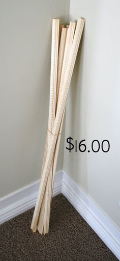 a tall wooden pole sitting in the corner of a room next to a white wall