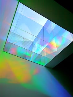 the ceiling is covered with multicolored light and shadows from the building's windows