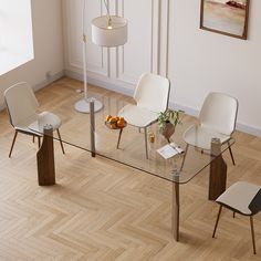 a glass table with four chairs around it