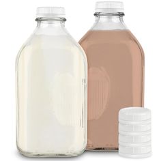 two glass bottles with lids are next to each other