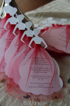 there are pink and white paper decorations on the table