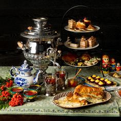 a table topped with plates and cups filled with food