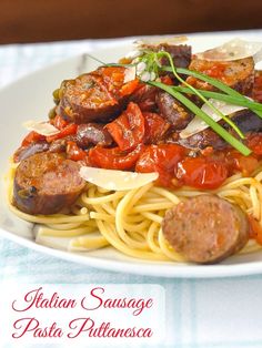 a white plate topped with pasta and sausage