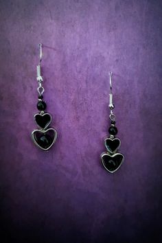 Introducing our stunning Gothic Black Heart Dangle Earrings! These captivating earrings are the perfect accessory for those with a dark and mysterious edge. Crafted with exquisite attention to detail, each earring features a beautifully intricate black heart design, symbolizing passion and intensity. These earrings are lightweight and comfortable to wear, ensuring you can showcase your unique style all day long. Whether you're dressing up for a Gothic-inspired event or simply want to make a statement, these earrings will add a touch of allure and sophistication to any ensemble. Embrace your inner darkness with our Gothic Black Heart Dangle Earrings and let them be a reflection of your unique personality. Each product is one of a kind so there might be slight variations in colour, thickness Black Heart Earrings As A Gift, Black Heart Earrings For Pierced Ears As Gift, Black Heart-shaped Earrings For Gift, Gothic Metal Earrings For Valentine's Day, Gothic Dangle Earrings For Valentine's Day, Black Heart-shaped Pierced-style Jewelry, Black Dangle Heart Pierced Earrings, Black Metal Jewelry For Valentine's Day, Black Sterling Silver Heart Earrings