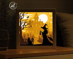 an illuminated halloween scene with a cat and witch