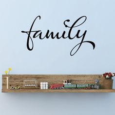 a wooden shelf with a toy train on it and the word family written in cursive font