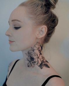 a woman with a flower tattoo on her neck