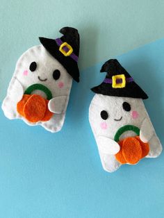 two small stuffed animals wearing witches hats