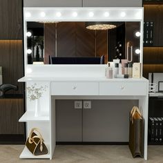 a white vanity with lights on it in front of a mirror and some bookshelves