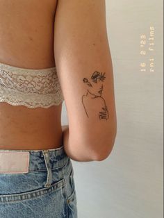 a woman with a tattoo on her arm