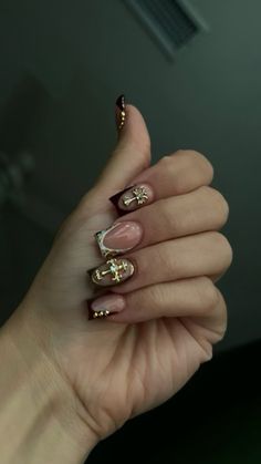 French tip maroon and gold nails with cross gems Black Gold French Tip Nails, Nails With Cross Gems, French Tip Maroon, Burgundy Gold Nails, Nails With Cross Charm, Maroon French Tip Nails, Maroon And Gold Nails, Brown And Gold Nails, Nagel Inspiration