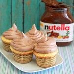 cupcakes with frosting on a plate next to nutella spread and jar of nutella