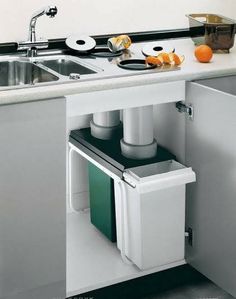 a kitchen sink with an open cabinet underneath it