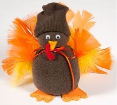 a stuffed toy penguin wearing a hat and orange feathers